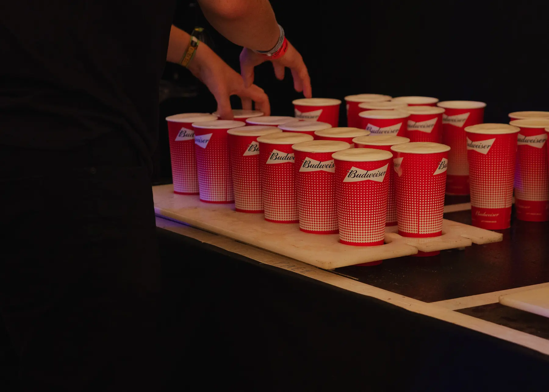 Branded cups of beer lined up for service