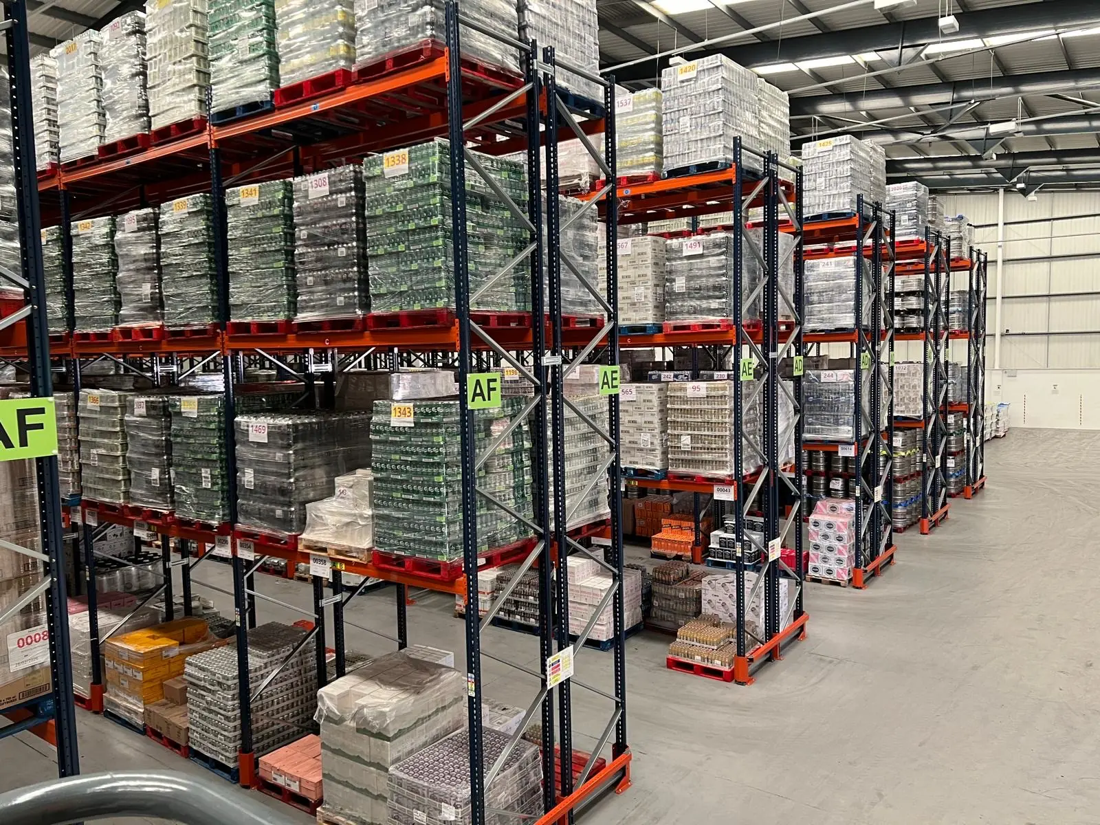 Pallets of canned drinks in warehouse racking