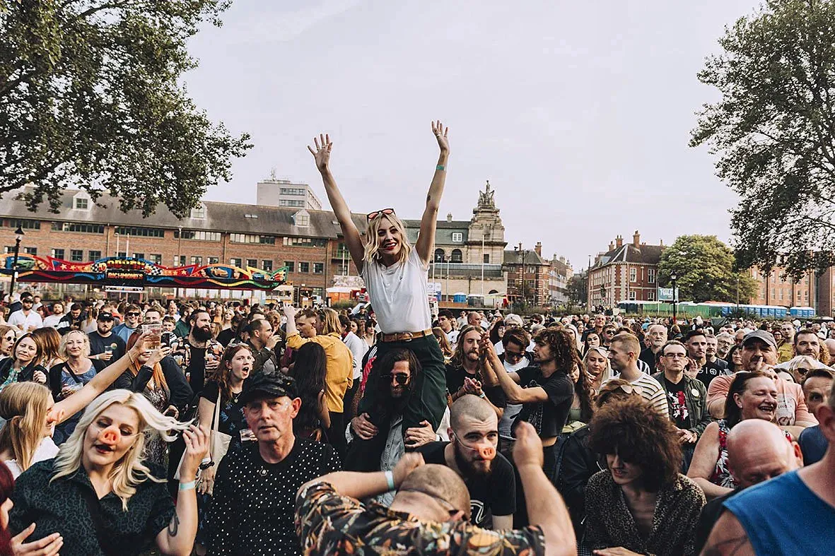 Crowd enjoying a city-centre street festival on a summer evening