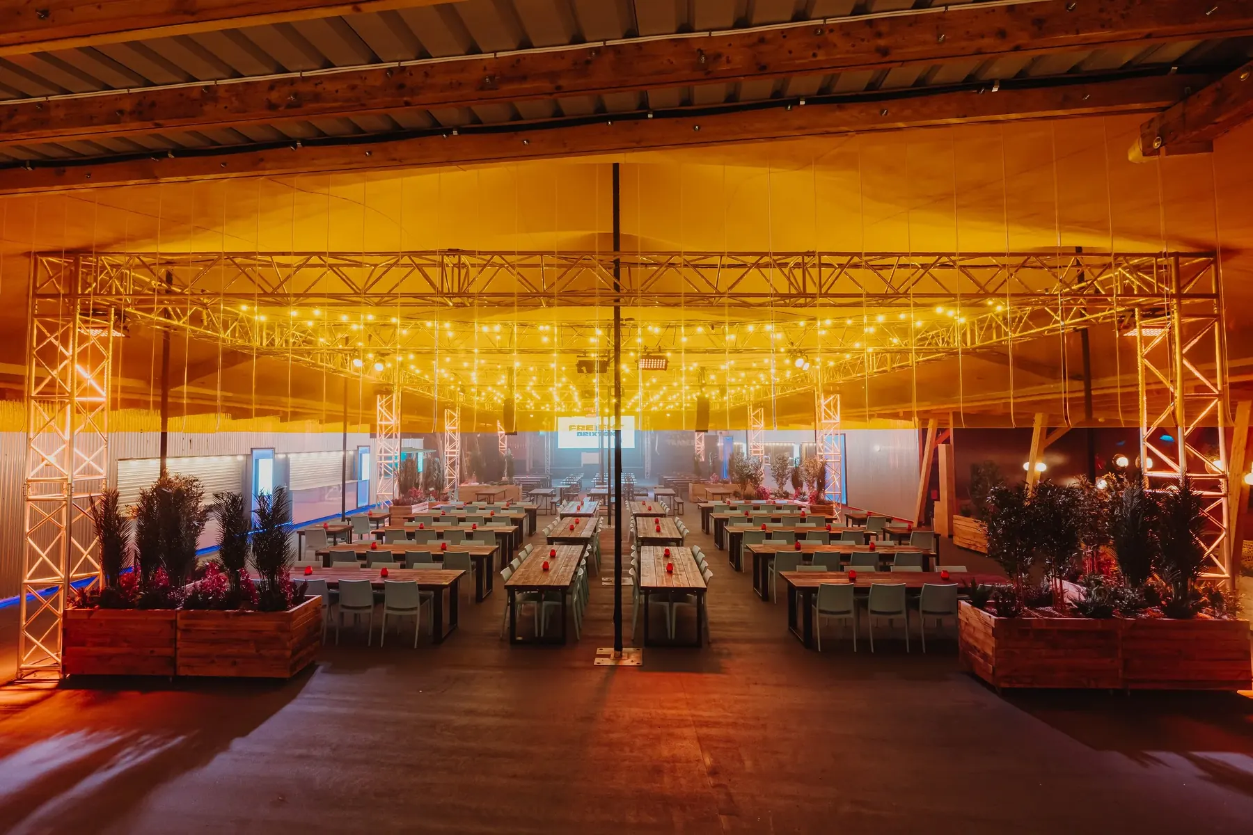 Covered dining space lit with festoon lights
